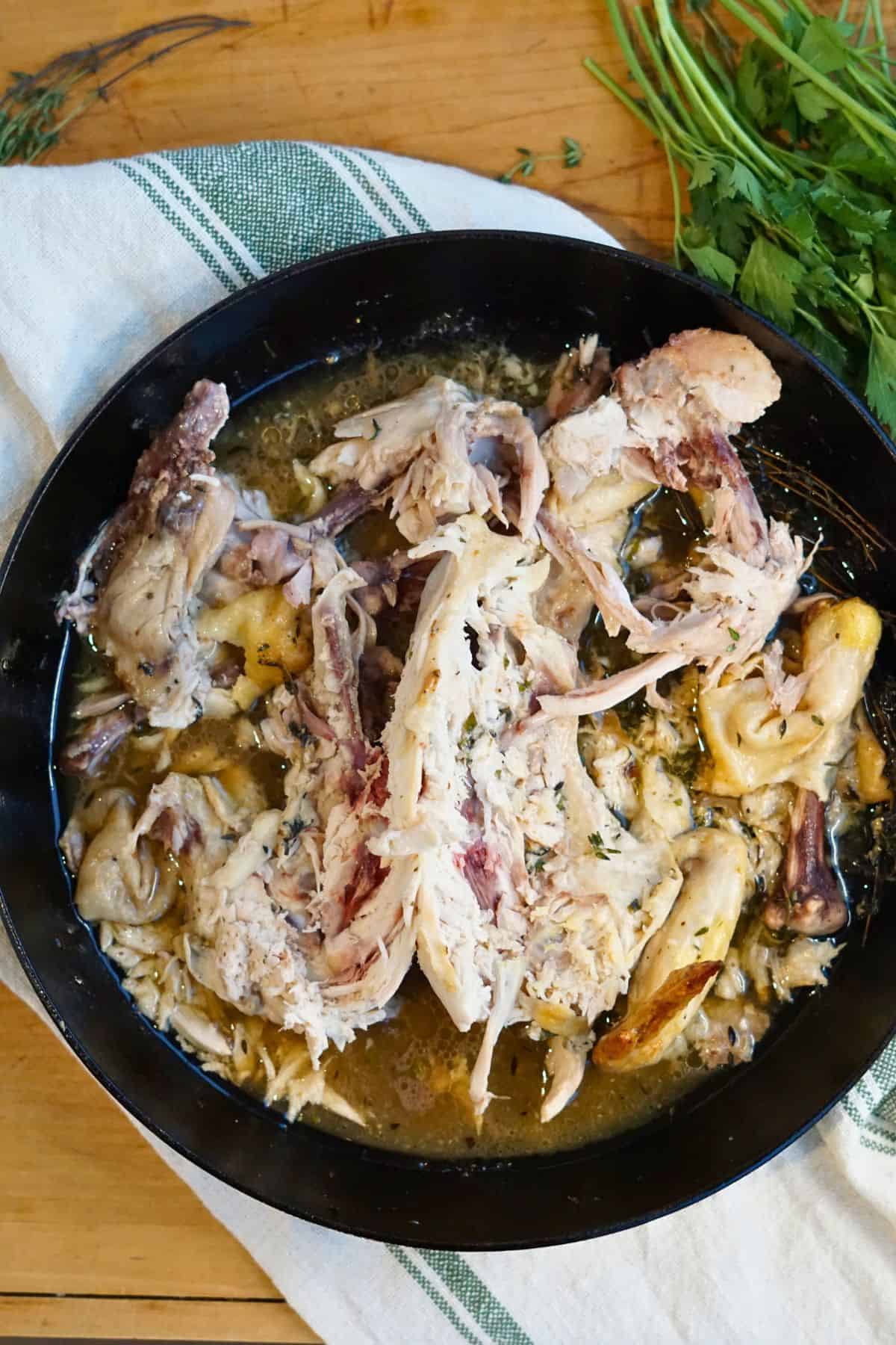 whole cooked chicken carcass in a cast iron skillet