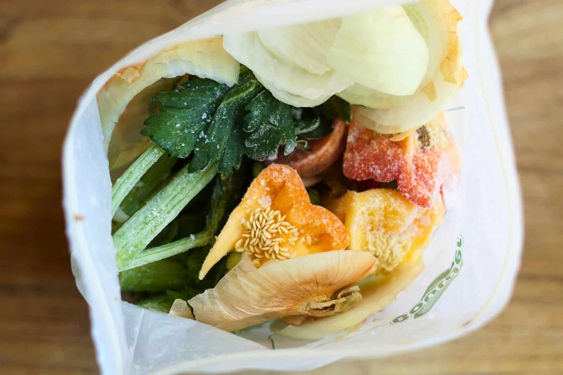 frozen vegetable scraps in a resealable bag