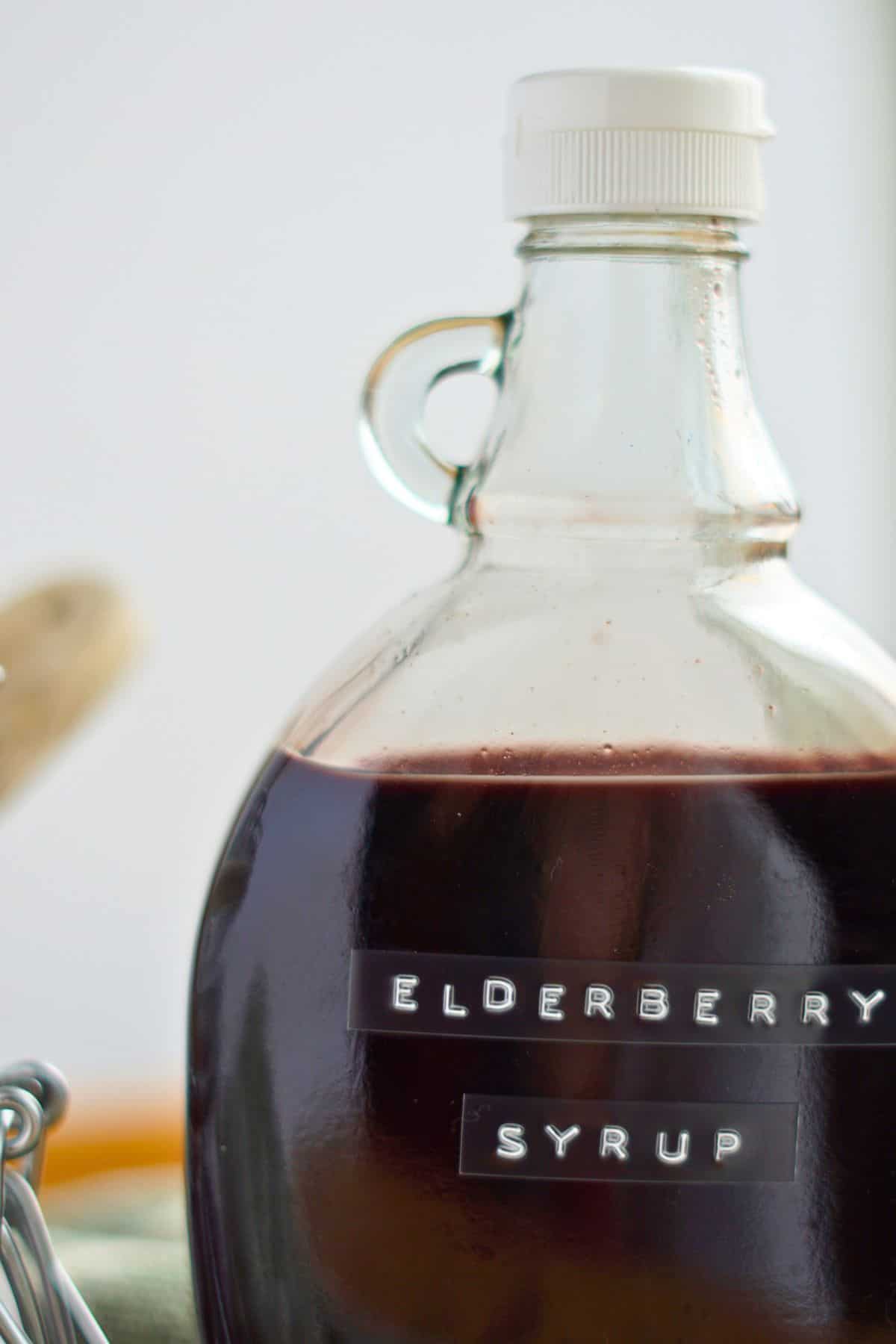 close up of elderberry syrup in glass jar