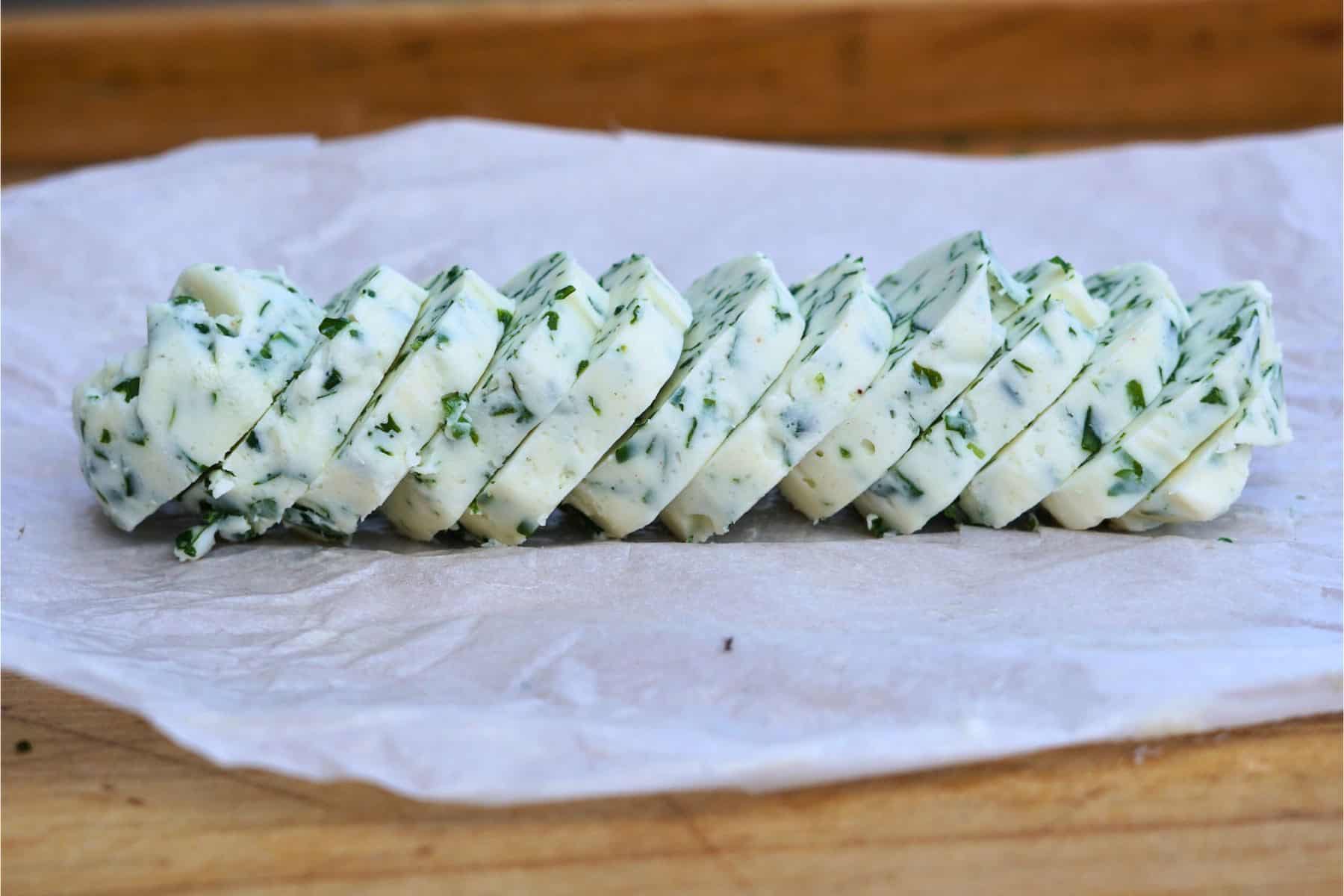 sliced chive compound butter on parchment paper