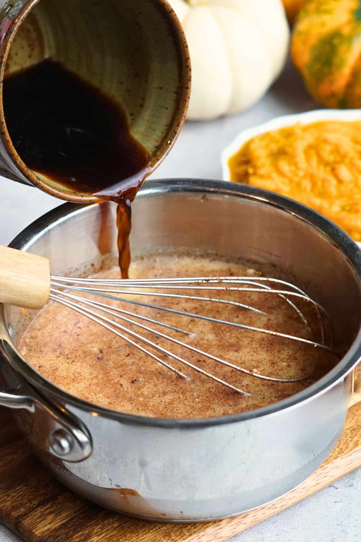 coffee pouring into small pot to make pumpkin spice latte