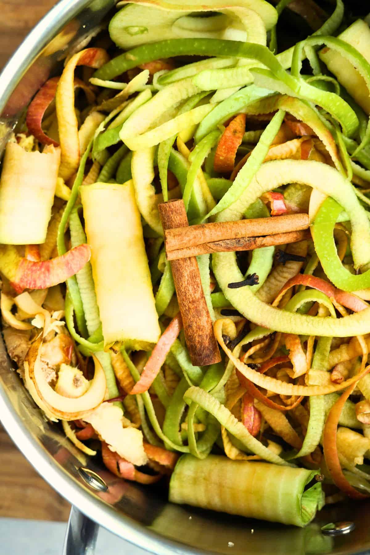 large pot of apple and pear scraps with whole spices