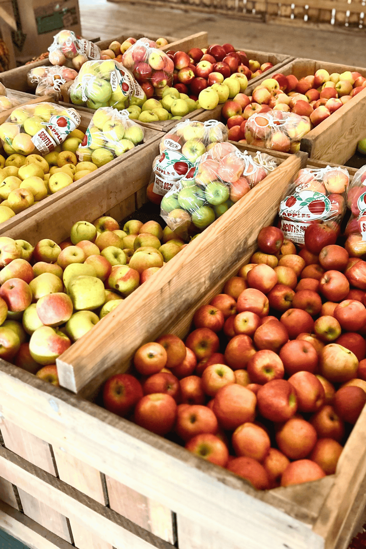varieties of apples in wooden crates at the market